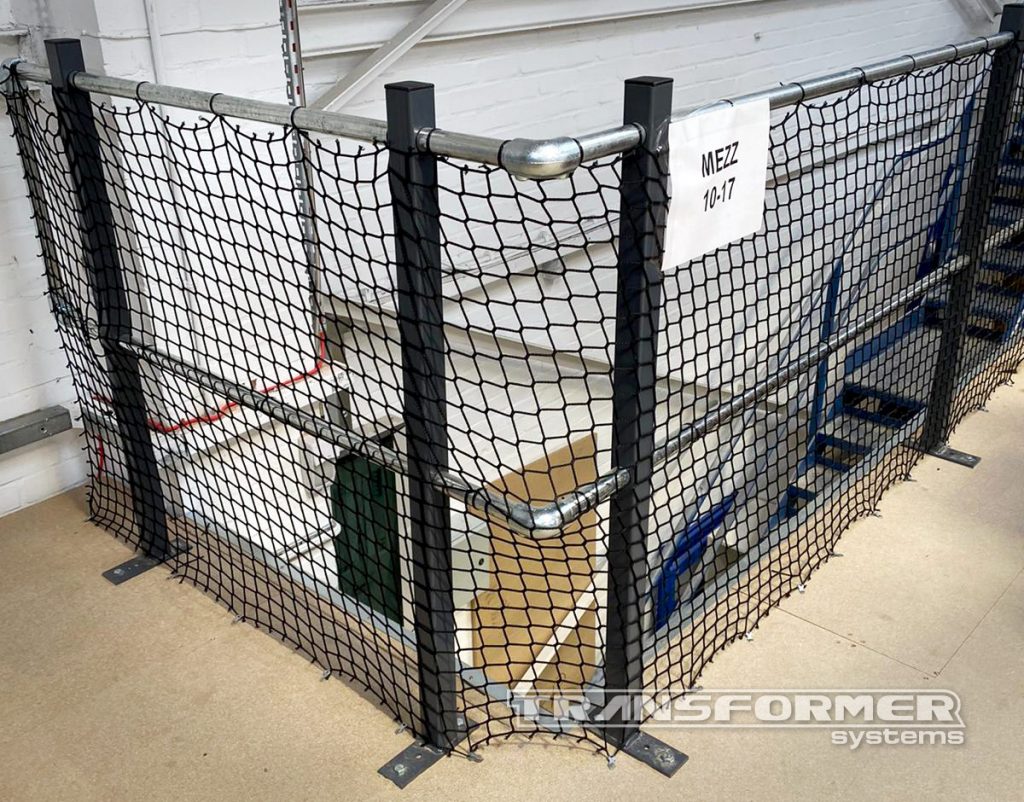 Handrail mesh netting protection to protect personnel below mezzanine floors.